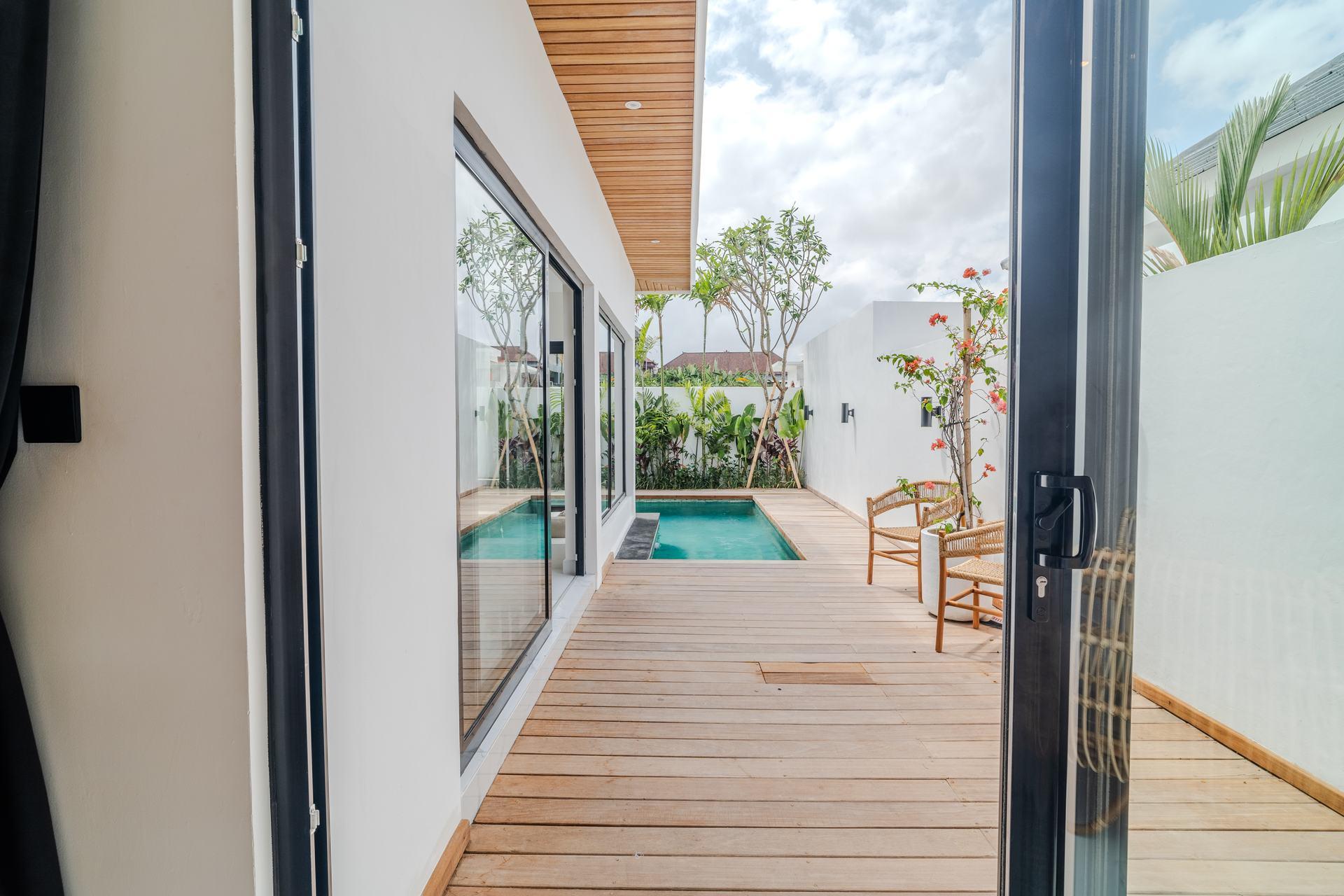 Wooden terrace of a villa in Bali opening onto the garden